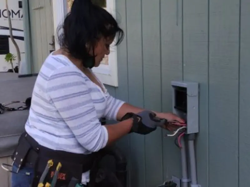 Licensed electrician wiring an exterior subpanel in Dakota Dunes