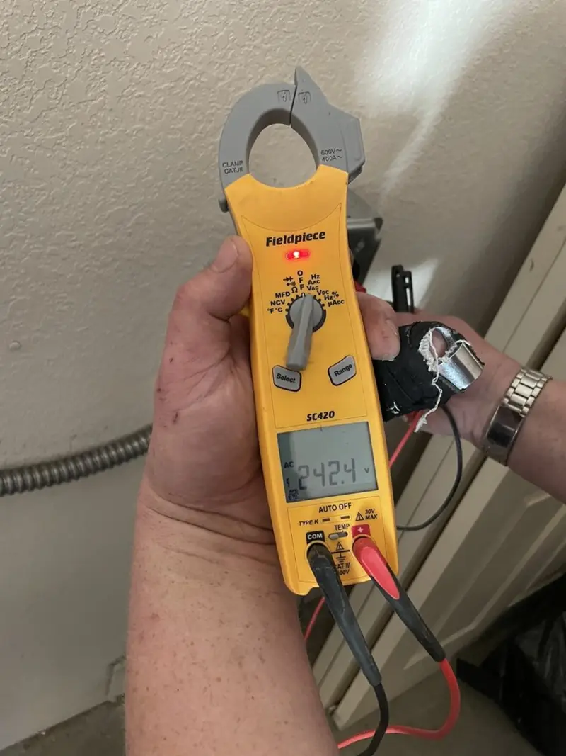 Voltage testing with clamp meter during Generator Installation in Dakota Dunes